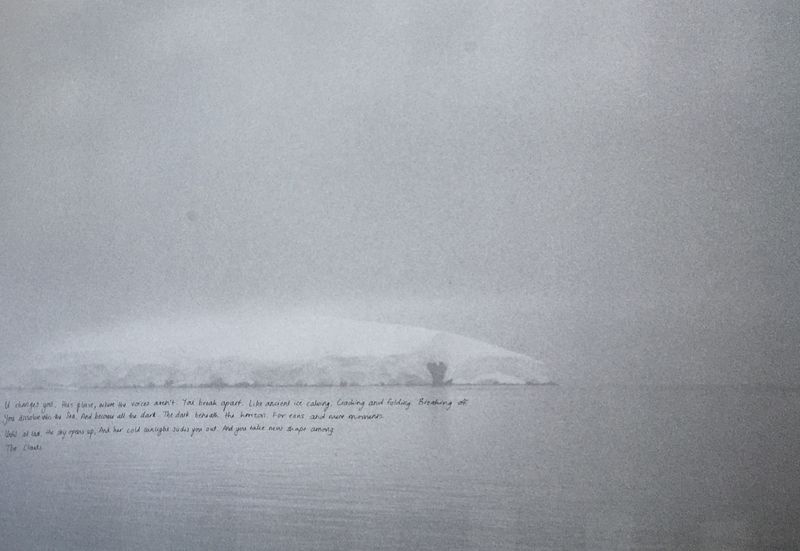 Pale grey horizon with a line of handwritten text